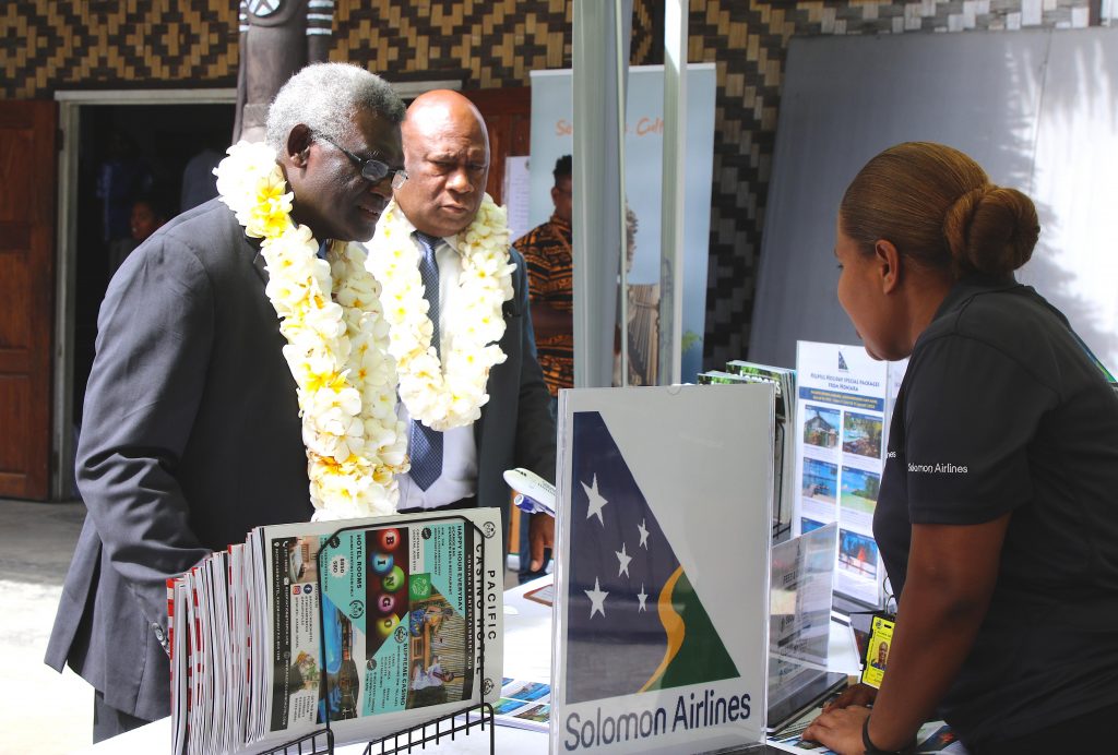 PM Sogavare and Tourism Minister Hon Parapolo visiting the Solomon Airlines booth.