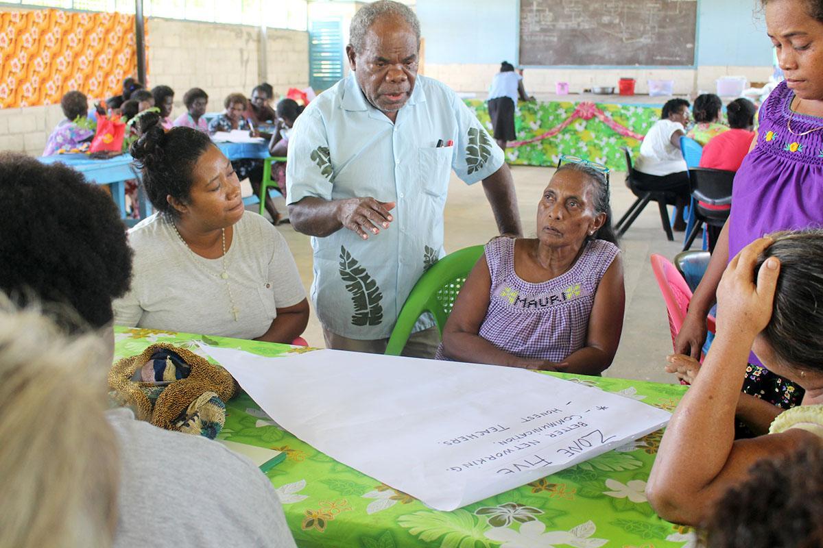 Solomon Islands National Council of Women (NCW) Women in Leadership Desk Officer, Casper Fa’asala, join in group discussion with the women