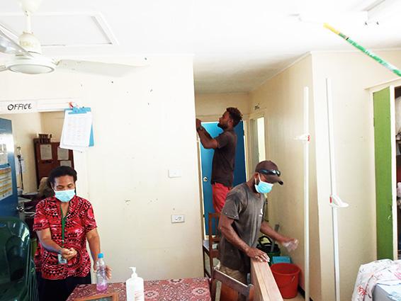 workers cleaning before painting the clinic