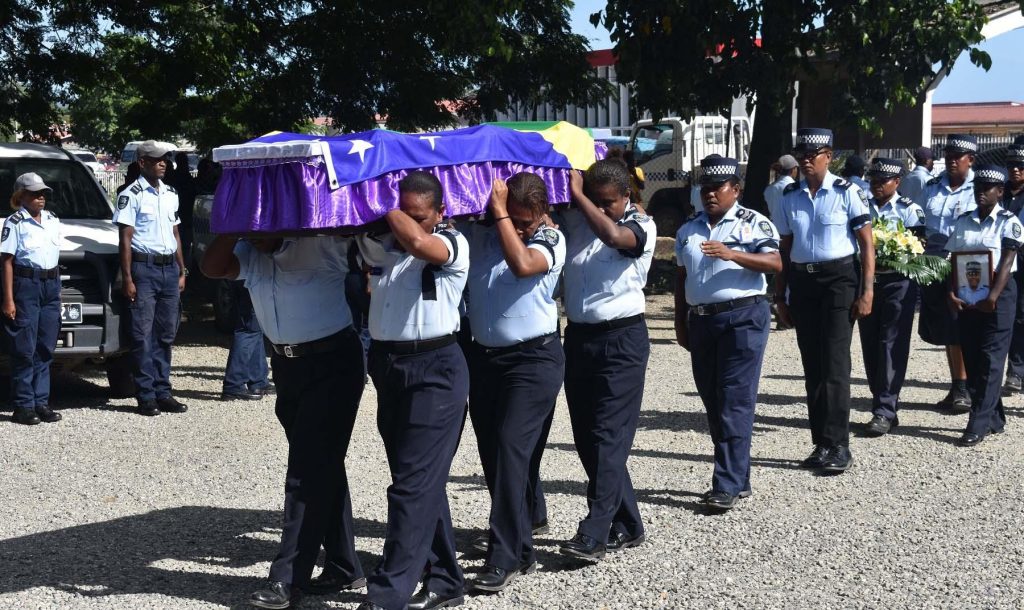 Officers carrying the casket of the late PC Elizabeth Kala Auna into the St. Barnabas Cathedral