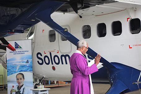 Retired Reverend Archbishop George Takeli blessing the aircraft