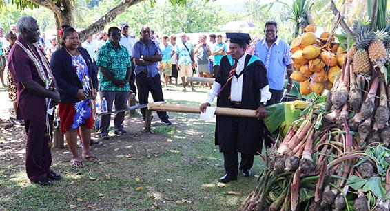 School principal Mr Leovaina presents a Chupu to the PM