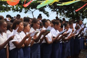 Selwyn College students sing during the handing over ceremony of the market and handwash facilities.
