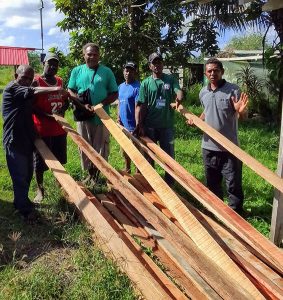 Papagu community members receiving the sawn timbers