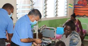 CEO handing out gifts at the NRH Children's Ward