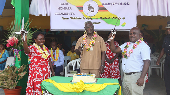 PM Sogavare (Center) and Minister of Finance and Treasury Honoarable Harry Kuma (Right) and President of Lauru Peoples' Association, Nanette Tutua. After cutting the Second Appointed Day cake.