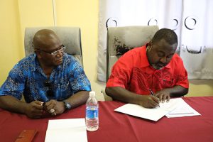 Hon Tausinga signs MOU as Minister Seloso looks on