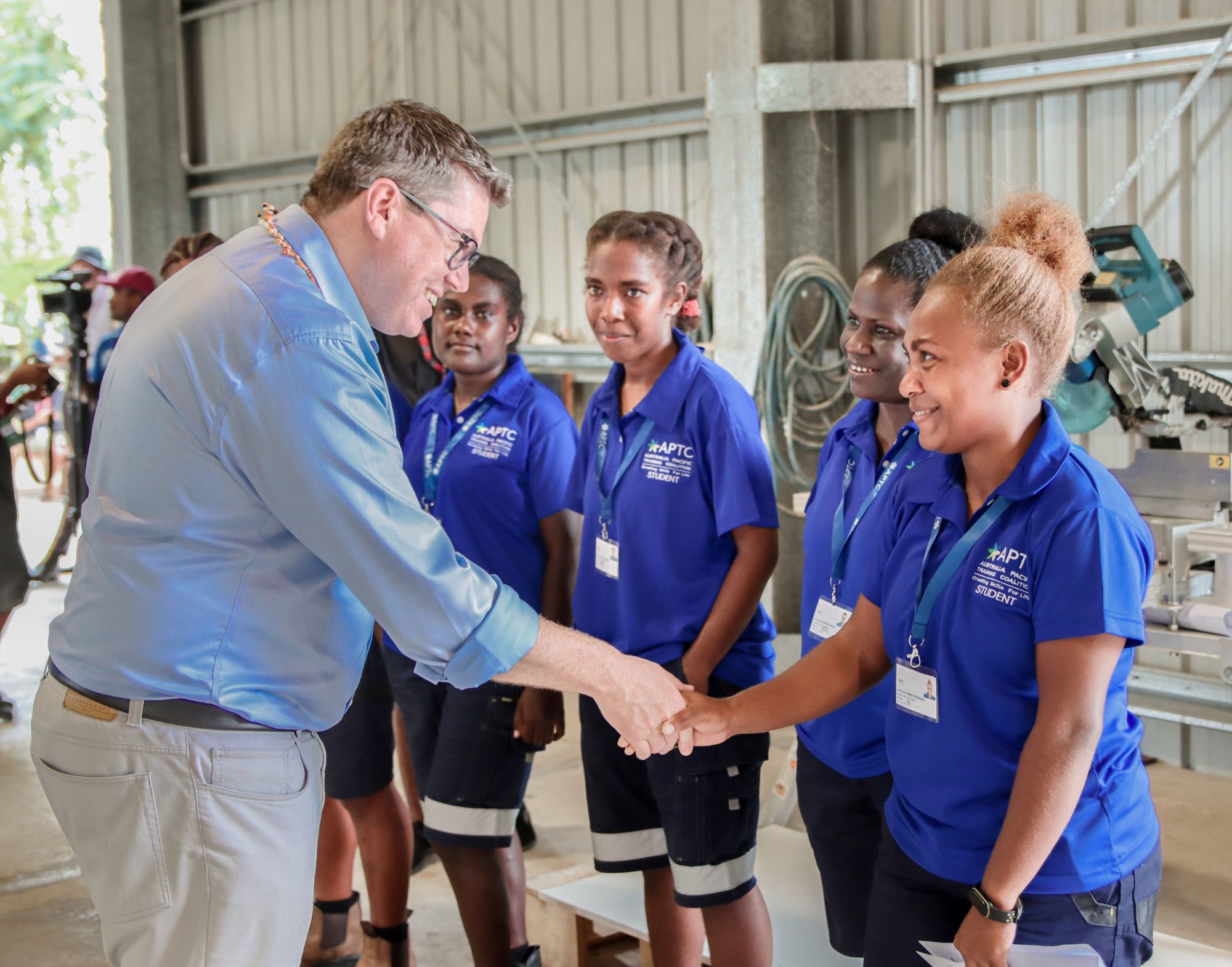 2. Australian Minister for International Development and the Pacific, Hon. Pat Conroy shares a light moment with a group of female students from the Construction course at the APTC Campus.