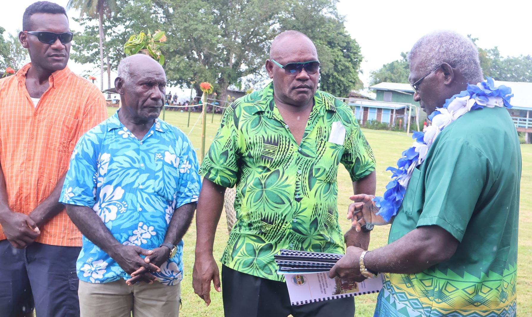 care- taker PM receiving the Wards Development Plans from one of the four MPAs while others witnessed the occasion.